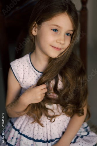 Portrait of little child with long hair