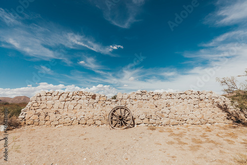 Fotografie Wagon Wheel Resting on Ancient Ruins in Hueco Tanks State Park