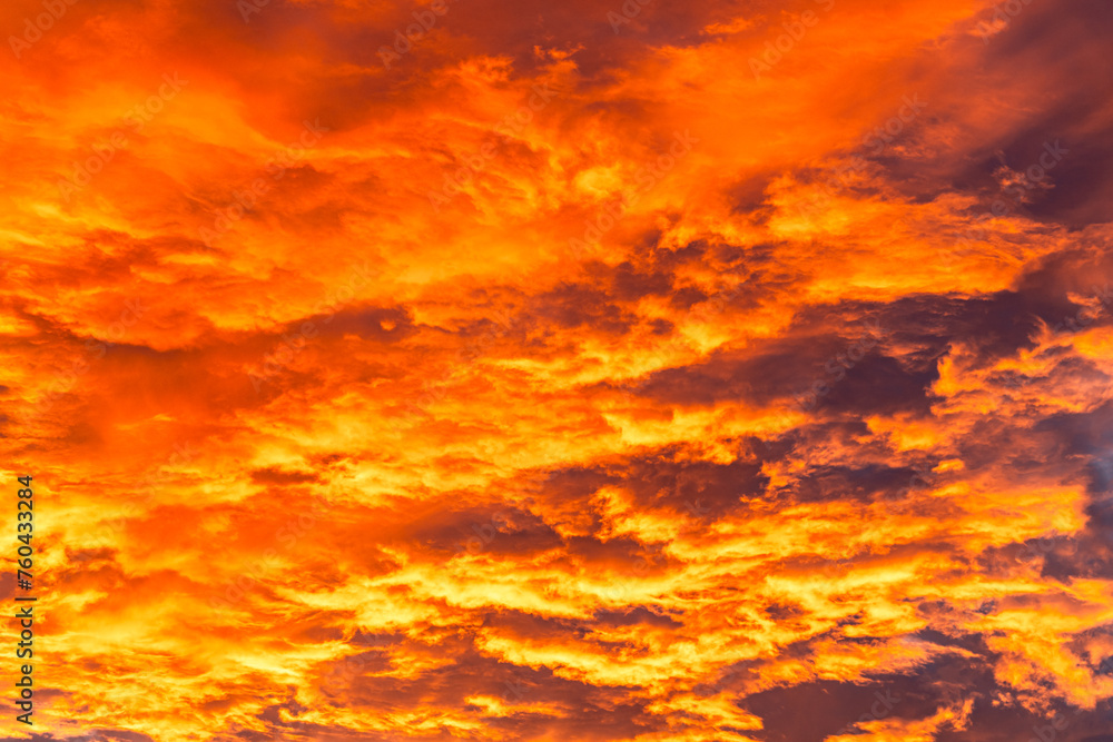 Sunset with cirrus clouds, beautiful cloud patterns at dusk, sunrise, orange clouds in the sky, sky background. Orange clouds and sky at sunset