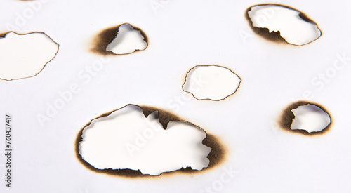 Fire burnt holes in a piece of paper