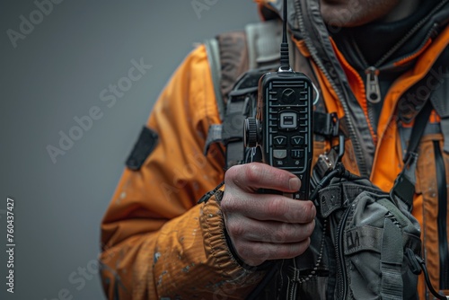 Close-up of a disaster response coordinator holding a radio communication device
