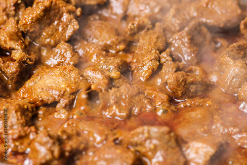 Close-up of beef rendang in the making, a popular traditional indonesian dish. Selective focus