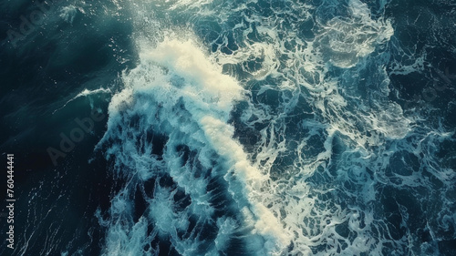 Aerial view of frothy ocean waves creating patterns of white foam.