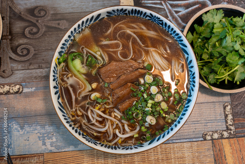 Closeup photo of beef rice noodle (pho), taken in a restaurant