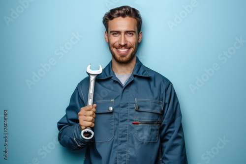 Professional mechanic holding a wrench in a workshop uniform