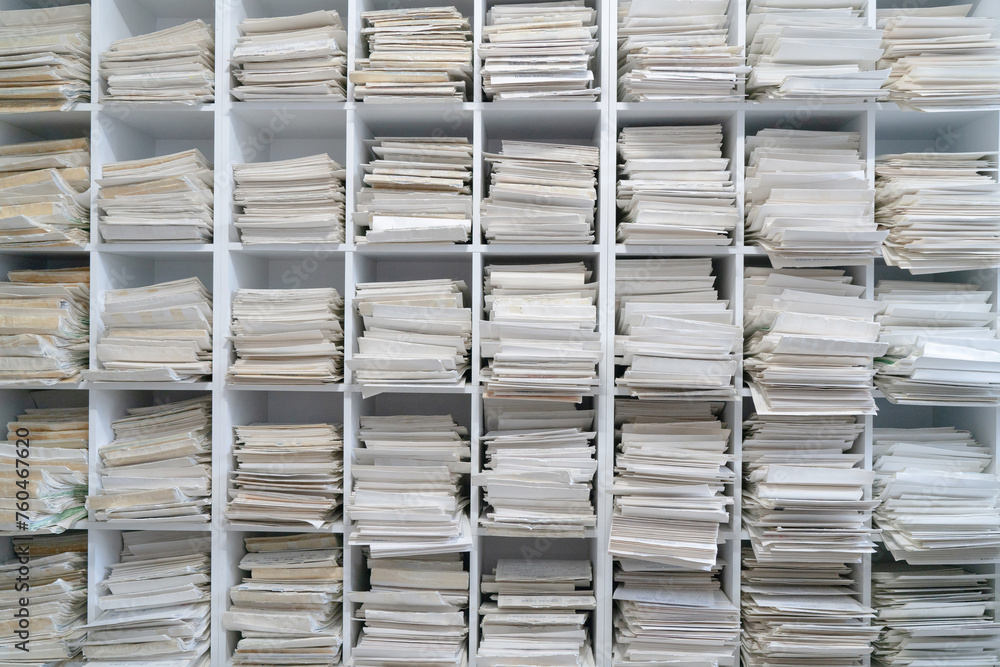 A stack of documents is piled up on the bookshelf. A stack of documents is piled up on the bookshelf.