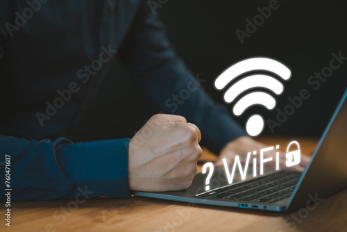 While using a laptop, a man faces difficulties connecting to WiFi, encountering either connection issues or incorrect password, leading to a delay in loading digital data from websites.