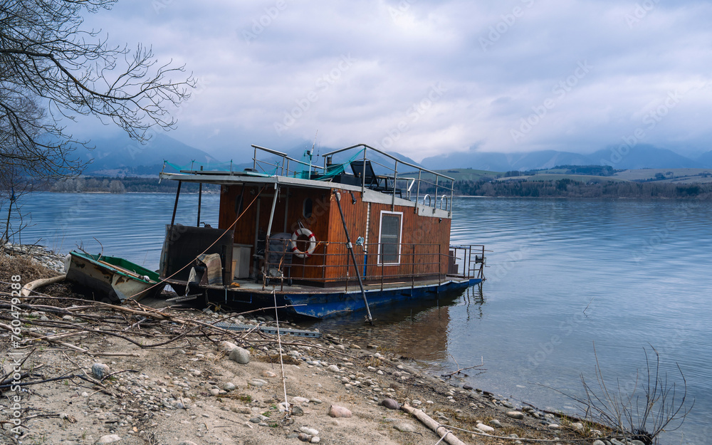 Houseboat anchored in the lake in Slovakia, Lipotvska Mara. Old houseboat, retro style living
