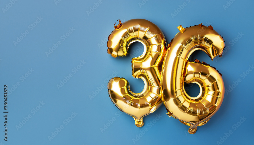 Obraz premium Banner with number 36 golden balloon with copy space. thirty six years anniversary celebration concept on a blue background.