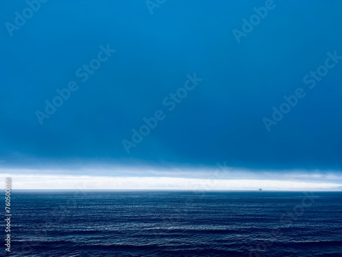 Dark cloudy sky at the ocean  deep blue seascape