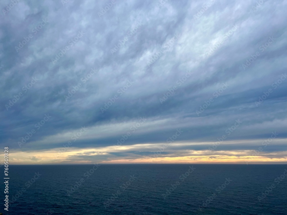 Dark cloudy sky at the ocean, deep blue seascape
