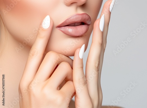 Close up view of young beautiful caucasian woman face over pink background. Lips contouring, SPA therapy, skincare, cosmetology and plastic surgery concept