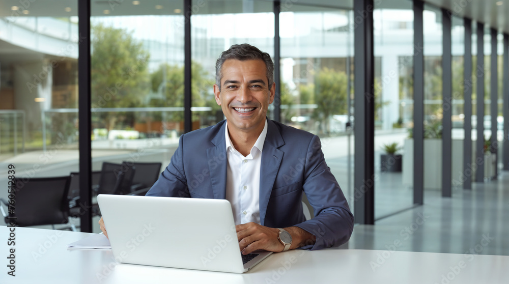 Mature latino businessman working on his laptop in a modern office, happy, smiling middle aged executive or ceo wearing a suit at work, hd Mature latino businessman working on his laptop in a modern office, happy, smiling middle aged executive or ceo wearing a suit at work, hd