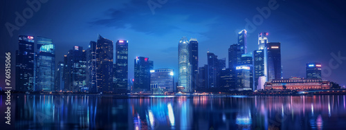 A city skyline is lit up at night  with the water reflecting the lights