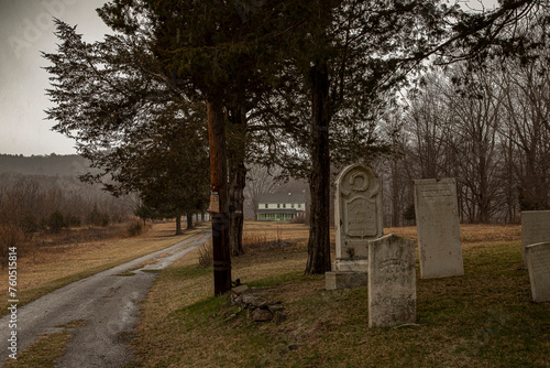 Abandoned farm house in the Delaware Water Gap National Recreation Area observed through a historical cemetery