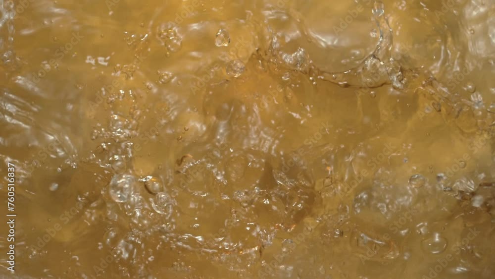 Splash of liquid texture with a yellowish tint. Texture of white wine or apple juice Splash of liquid texture with a yellowish tint. Texture of white wine or apple juice