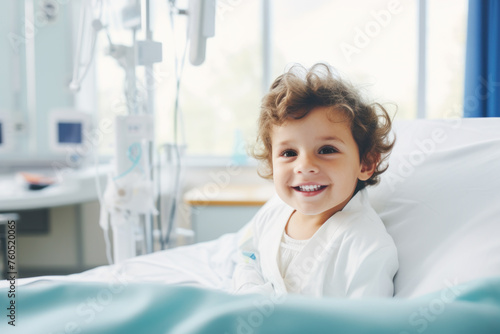 Little boy sitting on the hospital bed