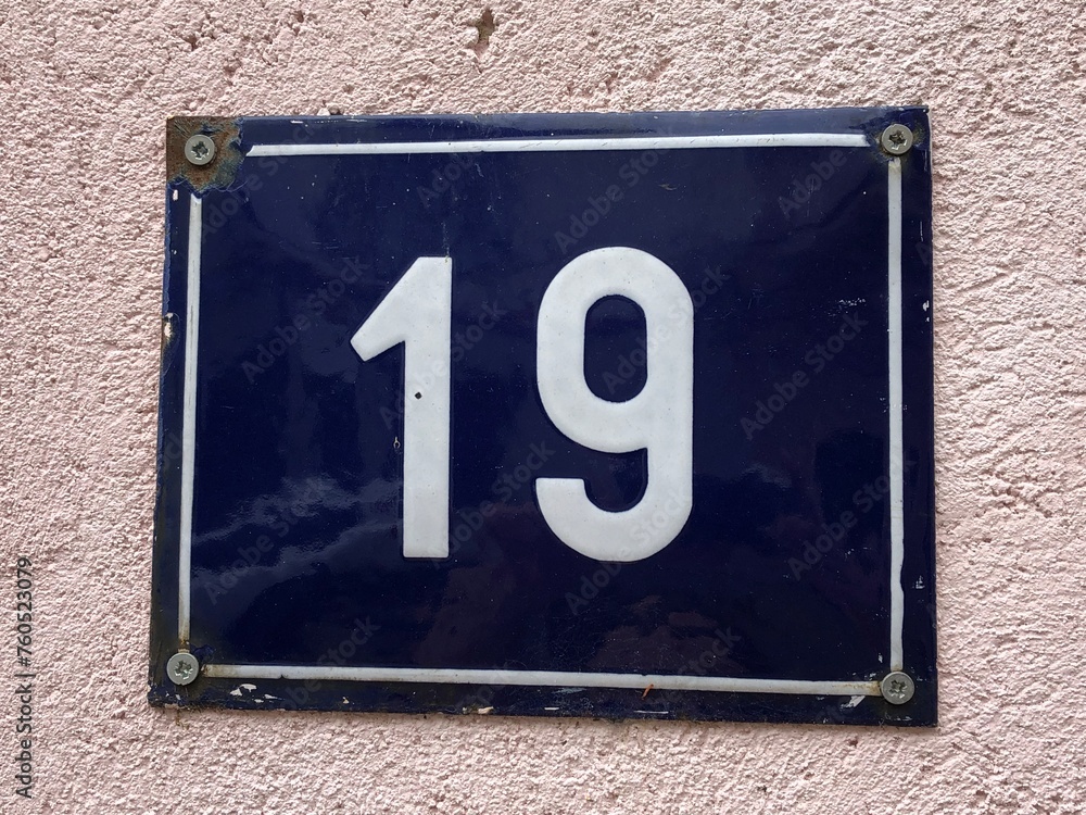 Blue metal numberplate that says number 19 Blue metal numberplate that says number 19