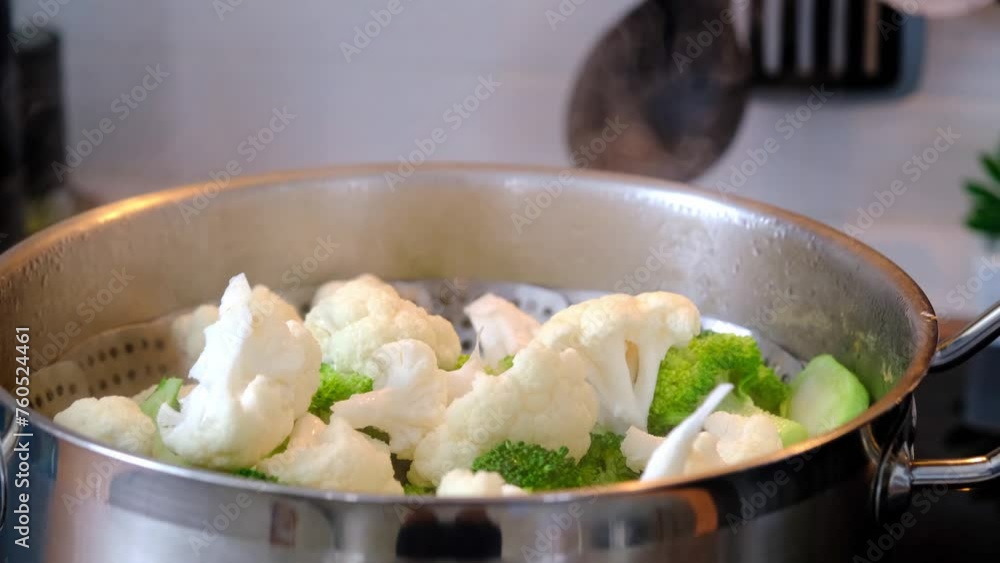 Broccoli and cauliflower are steamed in a saucepan - healthy diet, baby food, cooking in a steamer Broccoli and cauliflower are steamed in a saucepan - healthy diet, baby food, cooking in a steamer