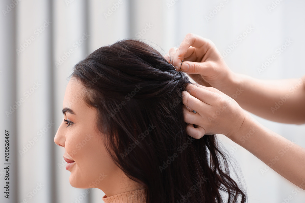 Fototapeta premium Hair styling. Professional hairdresser working with client indoors, closeup