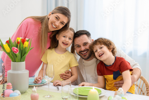 Easter celebration. Portrait of happy family at served table in room