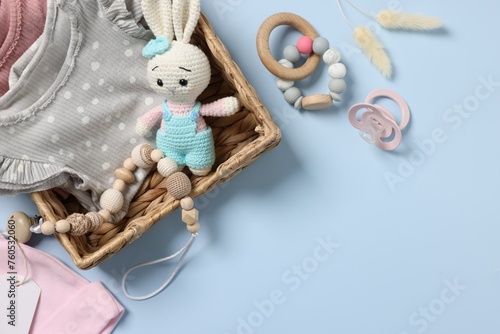 Flat lay composition with different baby accessories on light blue background, space for text