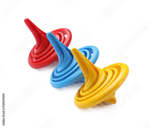 Three colorful spinning tops on white background © New Africa