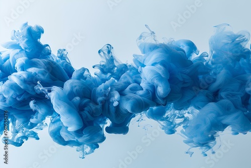 A blue substance is floating in the air with a white background and a white background behind it is photo