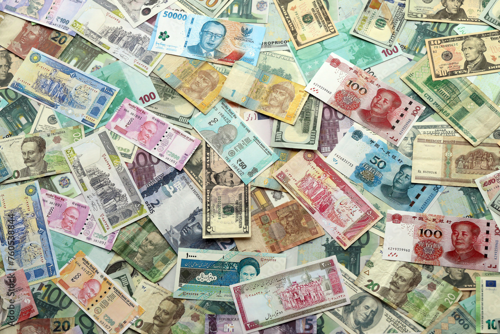Many banknotes of different currency. Background of big amount of random money bills close up Many banknotes of different currency. Background of big amount of random money bills close up
