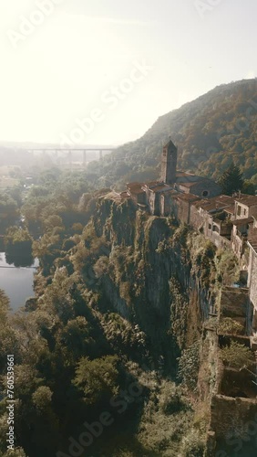 Castellfollit de la Roca at sunrise - 4K Drone Aerial Flyover - epic landscape of churches, cliffs, canyons, villages and forests - Catalonia Spain - incredible