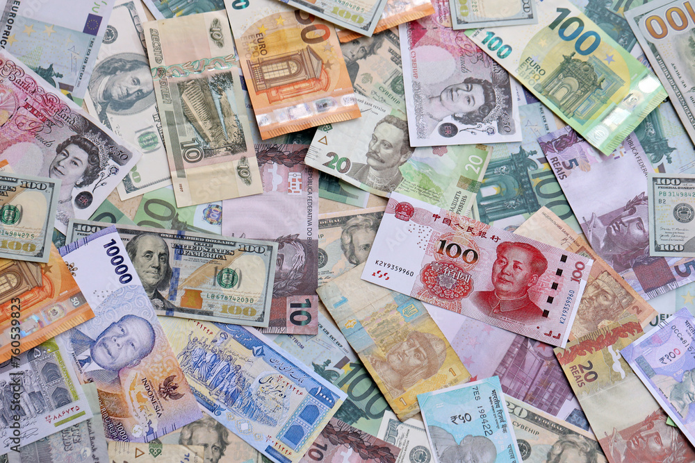Many banknotes of different currency. Background of big amount of random money bills close up Many banknotes of different currency. Background of big amount of random money bills close up