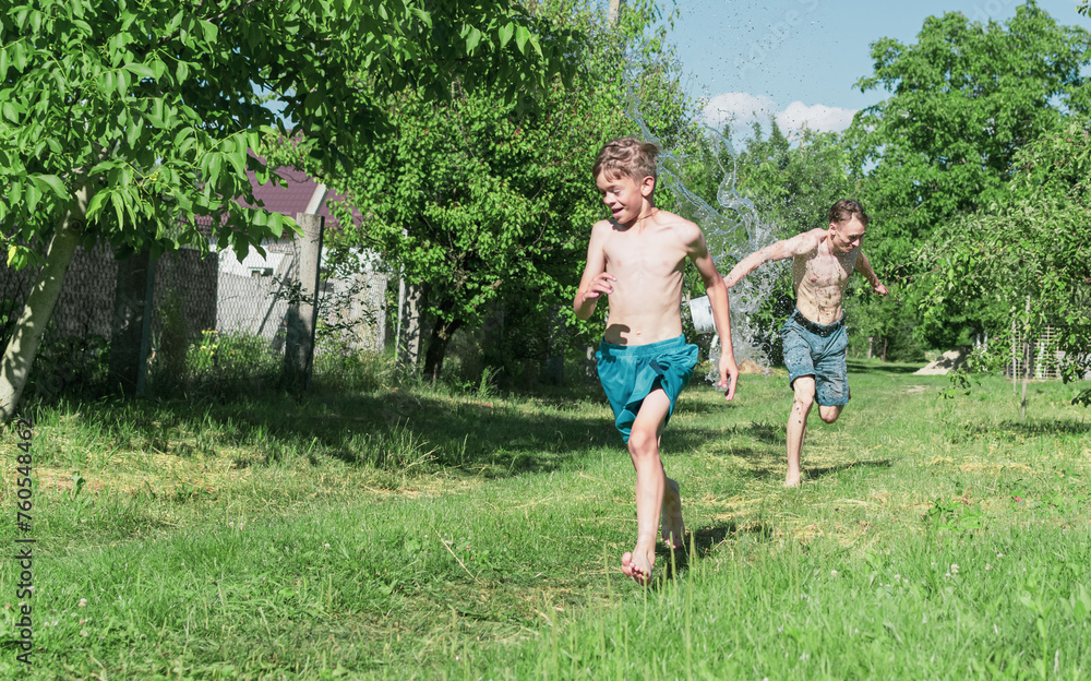 Obraz premium Two brothers pour water on a plot outside the city