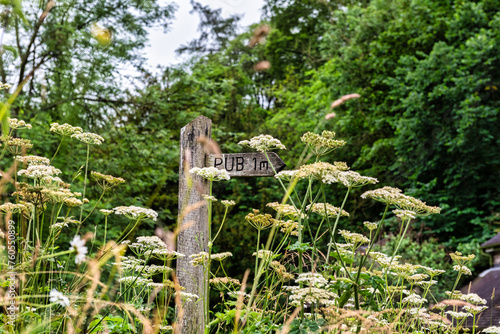 Pub sign direction viewed from the path between Dovedale and Milldale in the Peak DIstrict in Derbyshire, England