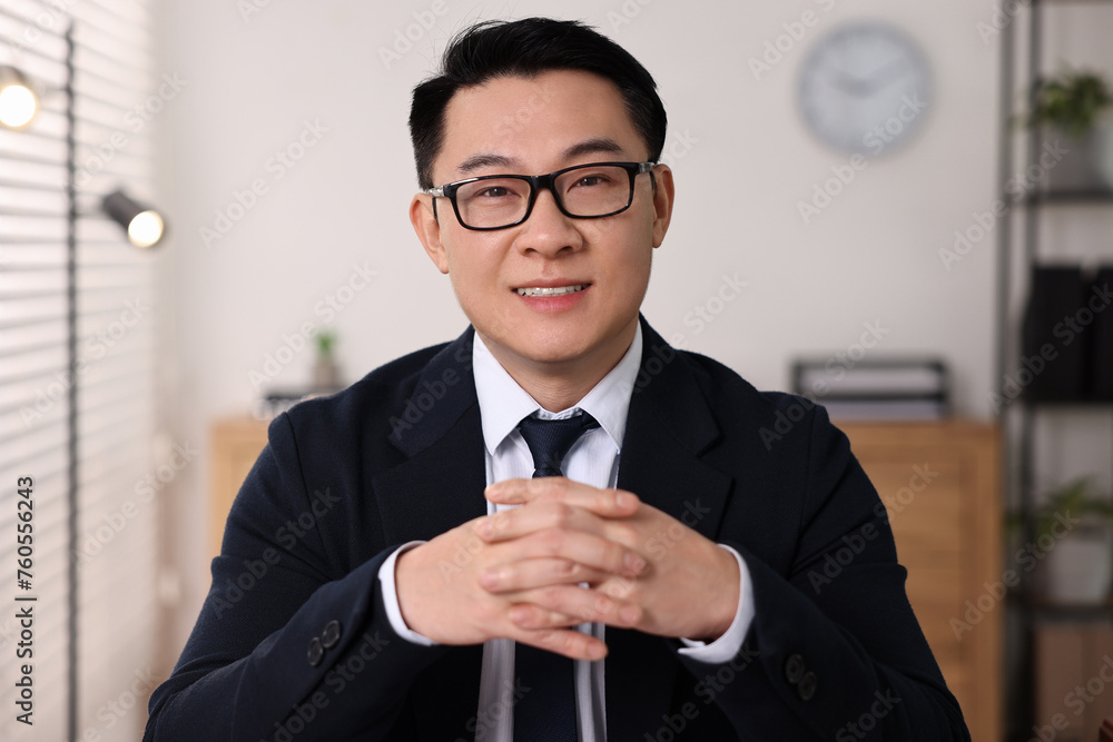 Portrait of confident notary working in office Portrait of confident notary working in office