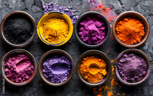 colorful holi powder in different bowls