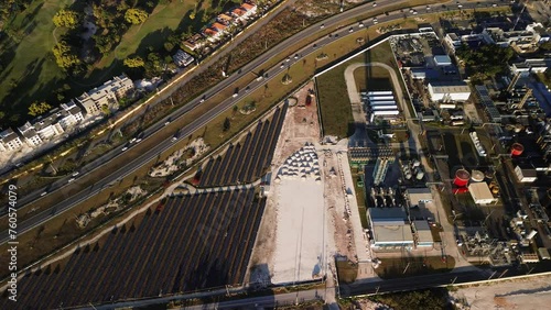 Aerial view of industrial zone with fuming chimneys. Heavy industry from above. Sunset. Coal-fired power station with solar panels and highway in Dominican Republic, Czech Republic, European Union