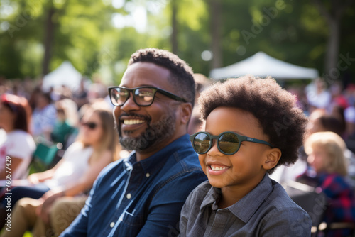 Black father and son attending interesting event