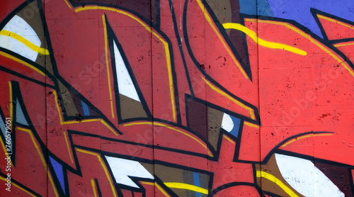 Colorful background of graffiti painting artwork with bright aerosol outlines on wall. Old school street art piece made with aerosol spray paint cans. Contemporary youth culture backdrop