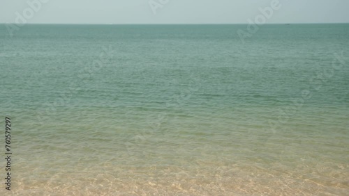 Horizon with sky and white sand tropical.
Wave sea of the on a beach sand background. 
