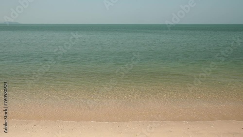 Horizon with sky and white sand tropical.
Wave sea of the on a beach sand background. 