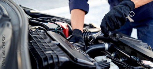 Photos Professional mechanic working on the engine , repairing a car engine automotive workshop with a wrench, car service and maintenance,Repair service