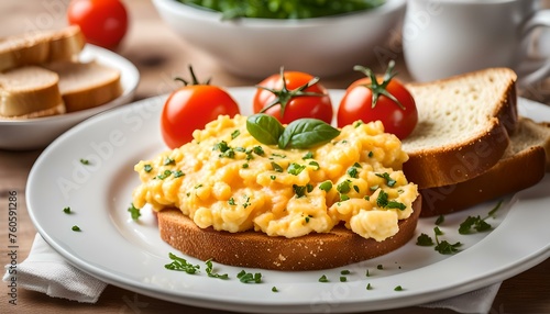 Scrambled egg served with toast and tomato 