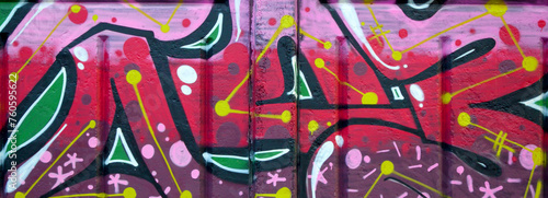 Colorful background of graffiti painting artwork with bright aerosol outlines on wall. Old school street art piece made with aerosol spray paint cans. Contemporary youth culture backdrop