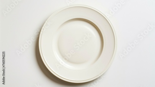 A simple white plate on a wooden table. Suitable for food and kitchen concepts