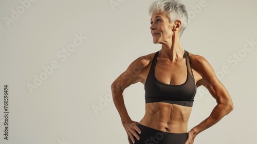 A fit older woman shows off her toned physique and excellent skin quality a testament to healthy living and physical activity at any age. Aging model. Menopause and weigh