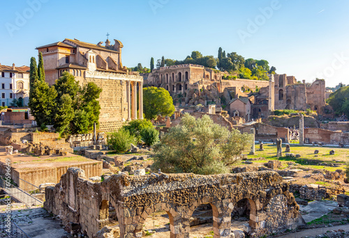 Temple of Antoninus and Faustina (Tempio di Antonino e Faustina) and ruins of Roman Forum, Rome, Italy photo