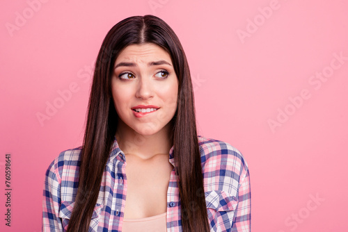 Close-up portrait of her she nice-looking attractive cute charming shine lovely worried puzzled straight-haired lady biting lip dont know isolated over pink pastel background © deagreez