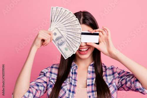 Close-up portrait of her she nice attractive cute charming lovely cheerful cheery straight-haired lady hiding behind cash card shopaholic isolated over pink background