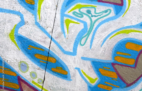 Colorful background of graffiti painting artwork with bright aerosol outlines on wall. Old school street art piece made with aerosol spray paint cans. Contemporary youth culture backdrop