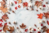 A white table covered with colorful autumn leaves. Perfect for fall themed designs